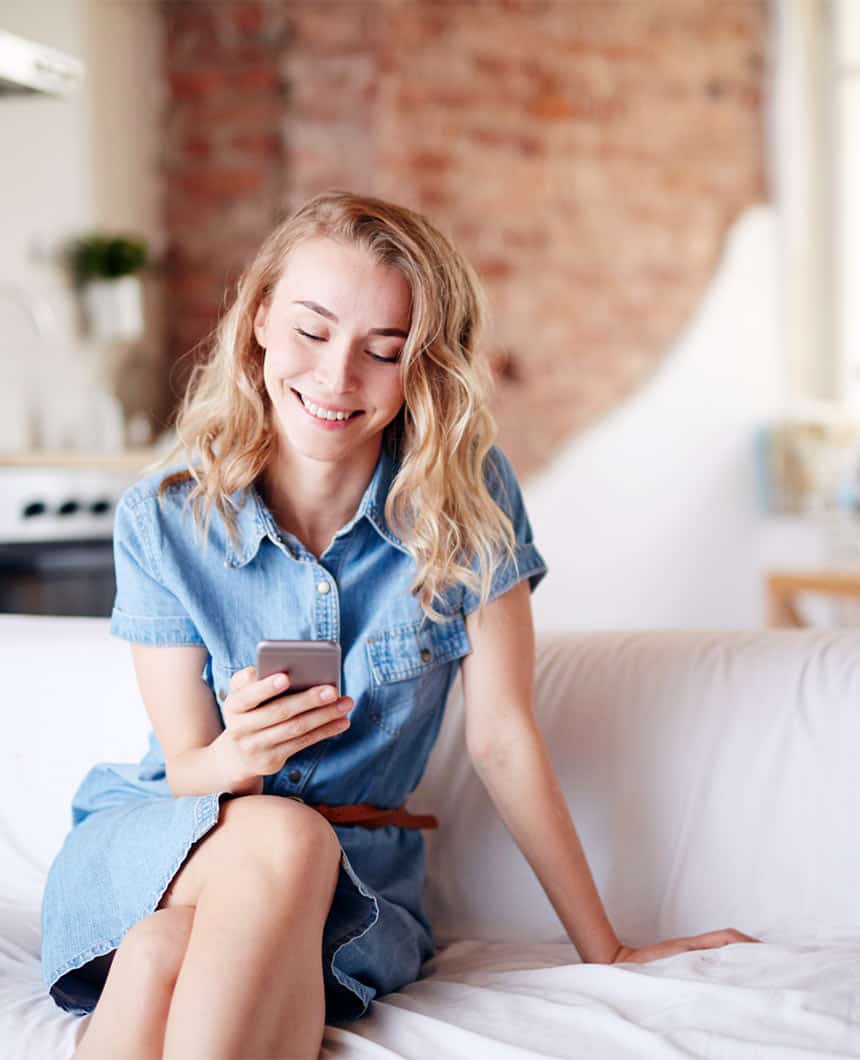 young woman sitting at home on couch