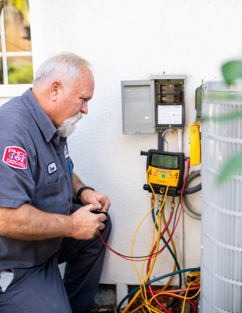 Technician inspecting home heating and air conditioning system