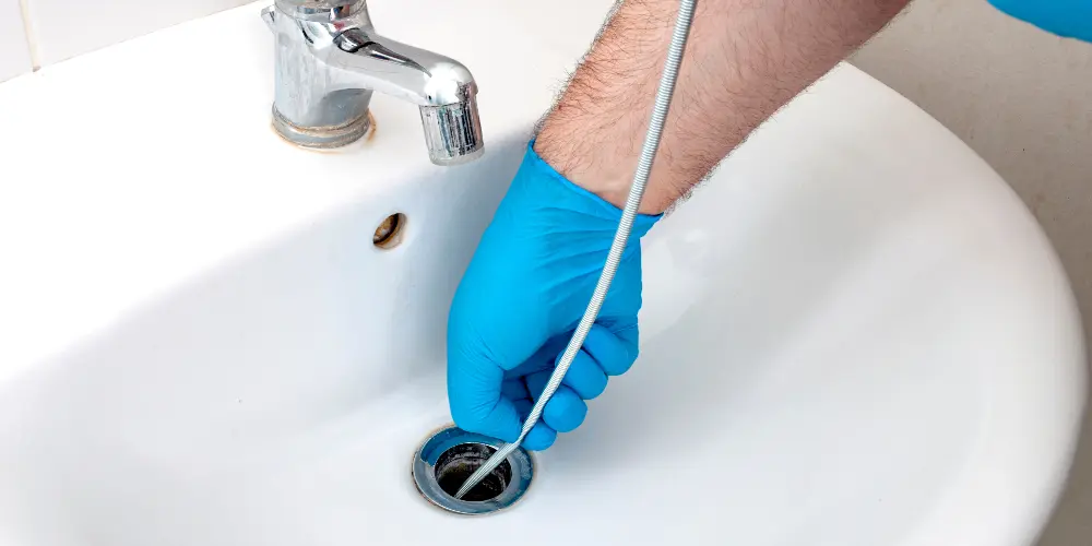 Unclogging 101: How to Use a Plumbing Snake for Hassle-Free Drain Fixes