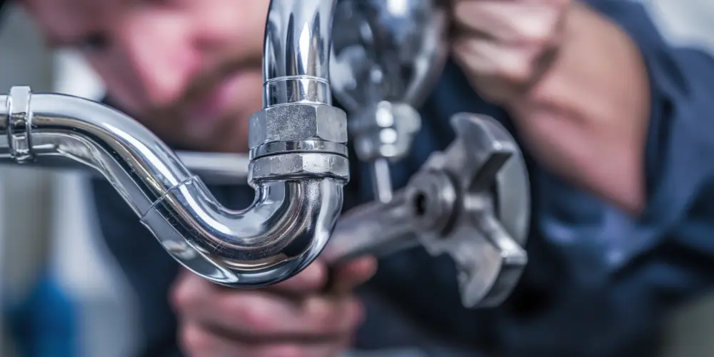 A Plumber Works on a P-Trap