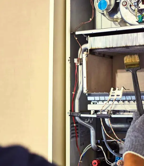 Technician maintaining a furnace