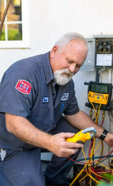 An OCP technician checks an air conditioner