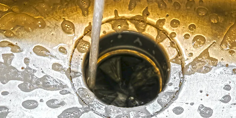 Water runnign down a garbage disposal